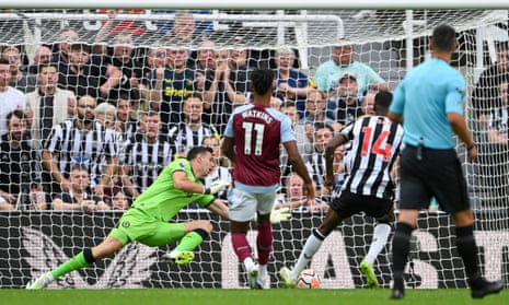 Alexander Isak of Newcastle United scores the team's second goal past Emiliano Martinez of Aston Villa.