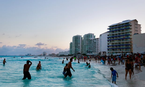 <br>Visitors wade at the shore of the beach in Cancun, Mexico in April 2015.
