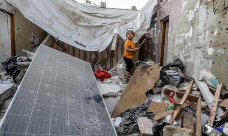 Palestinians, including children, collect remaining belongings from the rubble of destroyed houses after Israeli attacks on the house belonging to the Abu Gali family as Israeli attacks continue on Gaza Strip.