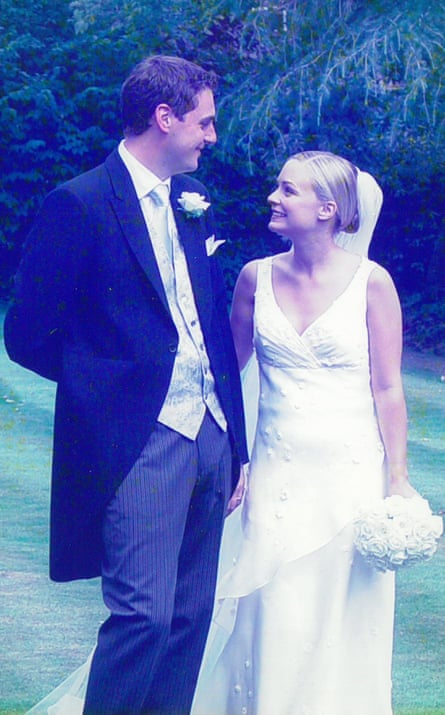 Lauren and Chris standing on a lawn in wedding outfits, gazing into each other’s eyes