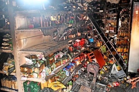 A shop after the riots with smashed shelves and products on the floor