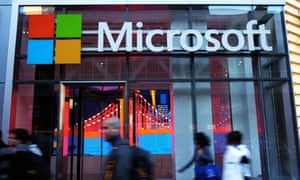People walk past a Microsoft office in New York - www.office.com/setup