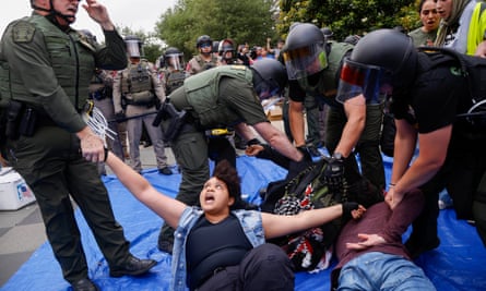 Protesters are taken into custody as law enforcement dismantle an encampment by pro-Palestinian students at the University of Texas at Dallas’ Chess Plaza on Wednesday.