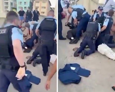 An image from a video posted to social media showing police apprehending the alleged shooters at Bondi and performing CPR.