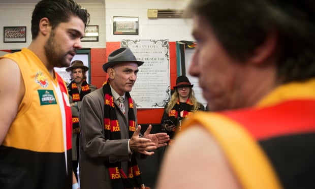 Dan Sultan (left), Tim Rogers (at rear) and Paul Kelly (centre) talk tactics in the Community Cup change rooms.