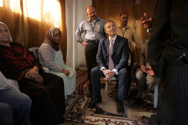 Blair meets a Palestinian family in the Kalandia refugee camp in 2007.