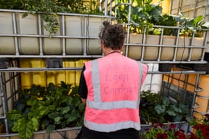 A man in hi-vis looks at a crowd