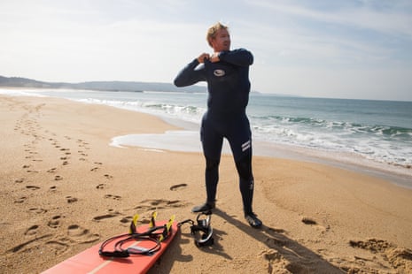 Cotton puts on his protective under-armour and wetsuit as he prepares for a paddle-surf in relatively tranquil conditions at Nazaré.