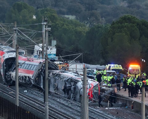 Emergency personnel work next to one of the trains involved in the accident.