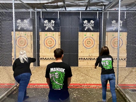 Maniax, Adelaide. Three participants take part in a game of axe throwing.