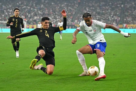 The Mexico midfielder Edson Alvarez (left) slides in on USA’s Damion Downs in July 2025