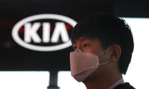 A man wears a face mask at the Kia standat the India Auto Expo 2020 in Greater Noida last week.