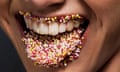 A woman’s tongue and lips covered in sugar sprinkles