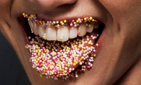 A lady’s tongue and lips lined in sugar sprinkles