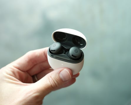 The Pixel Buds 2a held in their case with the lid open.