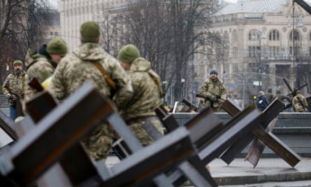 Members of the territorial defence forces guard a checkpoint in central Kyiv on 3 March 2022.