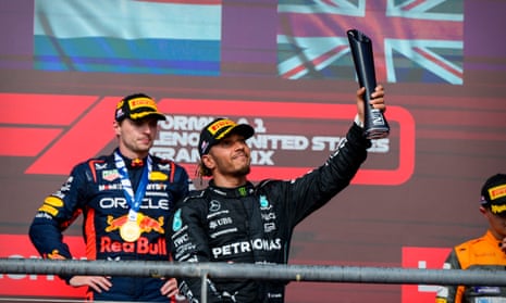 Lewis Hamilton celebrates on the podium at the US Grand Prix, before he was stripped of his position.