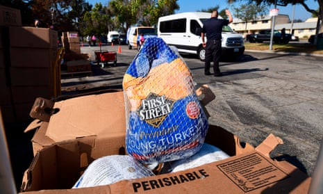 People arrive in their vehicles for a distribution of frozen turkeys and food boxes ahead of Thanksgiving to families affected by the Covid-19 pandemic in Los Angeles, California. The annual Operation Gobble Gobble event is organized by Supervisor Hilda Solis and 43 nonprofit organisations.