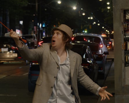 Matt Johnson standing on a city street holding something in his hand