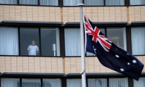 A hotel guest looks out from a window at the Holiday Inn at Melbourne Airport