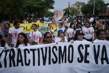 Crowds of people marching behind a banner
