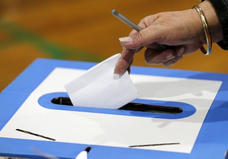 Hand placing vote in a box