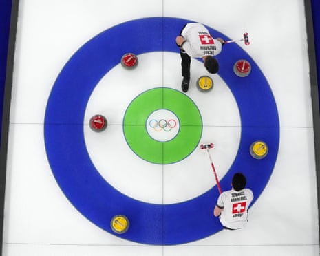 Switzerland’s Benoit Schwarz-van Berkel and Pablo Lachat-Couchepin inspect their stones in their match against Italy.