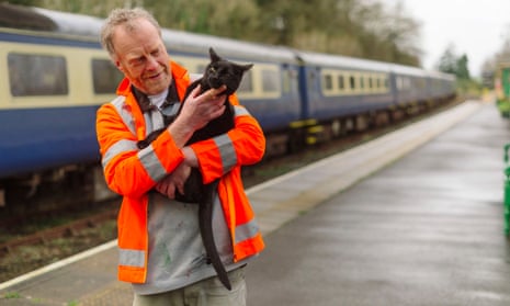 Paul Martin, duty manager, at Okehampton station with Percy, the station cat
