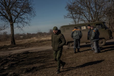 Mykola Kovalenko walks past electricity workers