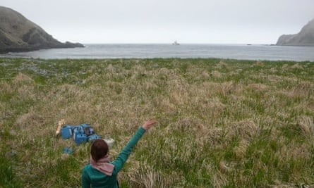 Rachel Buxton waving goodbye to the ship that dropped her on Amatignak