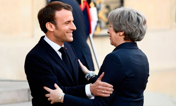 Emmanuel Macron, the French president, welcomes Theresa May to the Elysee Palace.