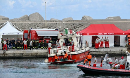 Divers of the Vigili del Fuoco, the Italian fire and rescue service, arrive in Porticello, near Palermo