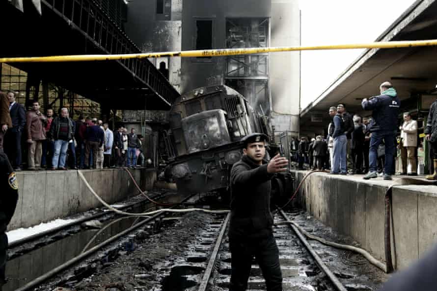 A policeman stands guard after a train rammed into a barrier at Ramsis station in Cairo, 27 February