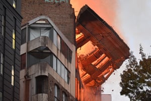 The facade of the building continues to collapse