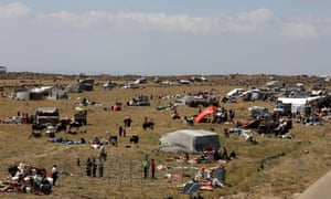 Internally displaced people from Deraa province are gathered near the Israeli-occupied Golan Heights in Quneitra, Syria. 