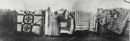 Damp river air … a woman drying quilts circa 1900.