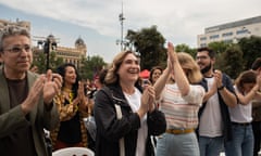 Ada Colau, clapping and smiling, surrounded by people clapping in an open space in Barcelona