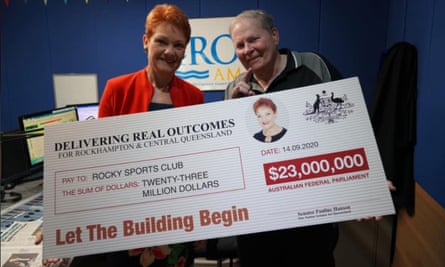 One Nation leader Pauline Hanson (left) poses with a $23m novelty cheque to Rocky Sports Club on Monday.