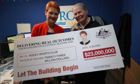 One Nation leader Pauline Hanson (left) poses with a $23m novelty cheque to Rocky Sports Club on Monday. 