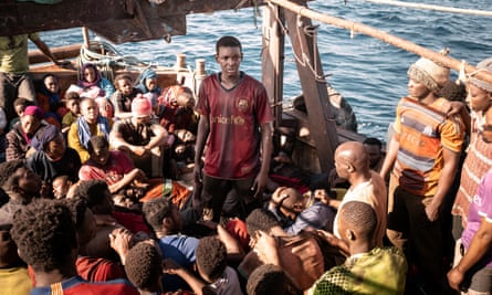 A still from the film Io Capitano showing African migrants in a desperately overcrowded boat making the dangerous journey across the Mediterranean to Europe.