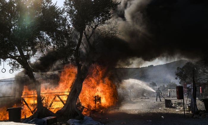 MORIA, GREECE - SEPTEMBER 10: A Greek firefighter tries to put out a flame as fires which started Tuesday night continue to rage into Thursday morning inside of Moria camp on September 10, 2020 in Moria. (Photo by Byron Smith/Getty Images) BESTPIX