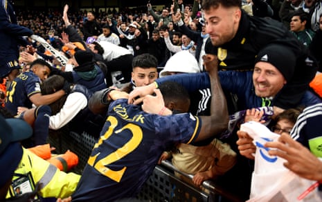 Real Madrid’s Antonio Rüdiger (right) and Rodrygo (left) celebrate with fans after winning the penalty shoot-out.