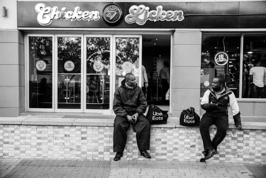 Ghost riders: the invisible lives of Johannesburg food couriers – photo essay | South Africa 13 Mande waits for an order.