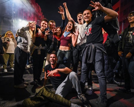 In Belgrade, celebrating crowds cheer and gesture on the street after Serbian election results