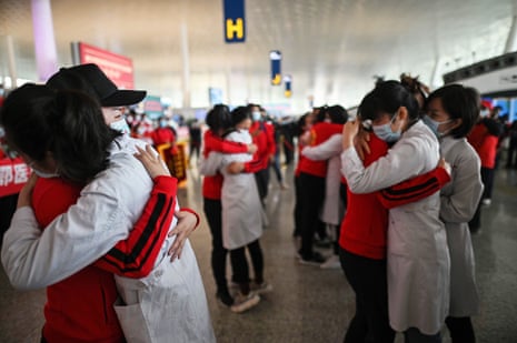 Medical staff from Jilin Province (in red) hug nurses from Wuhan