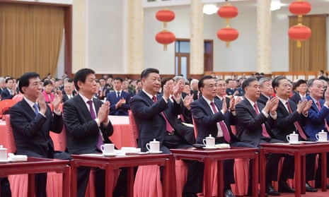 Xi Jinping (third left) and party leaders attend a lunar new year reception. State media has downplayed the coronavirus outbreak, despite 25 deaths in China.