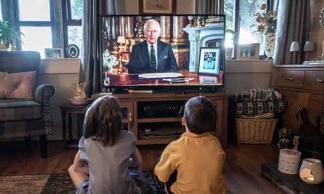 Children watch the first televised address by King Charles III