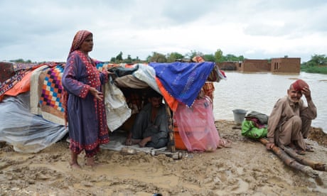 Family living in makeshift tent in mud by area of flood water. Family living in makeshift tent in mud by area of flood water.