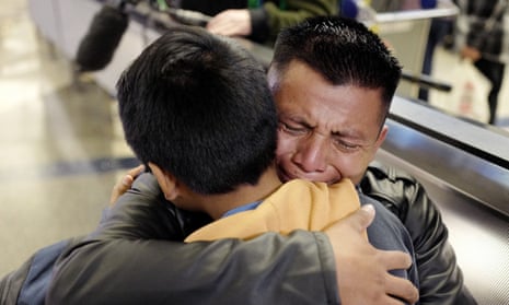 David Xol-Cholom, of Guatemala, hugs his son Byron at Los Angeles international airport as they reunite after being separated by the Trump administration.