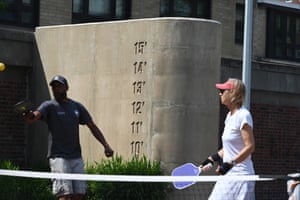 Flood level markings near the tennis courts where people are playing tennis